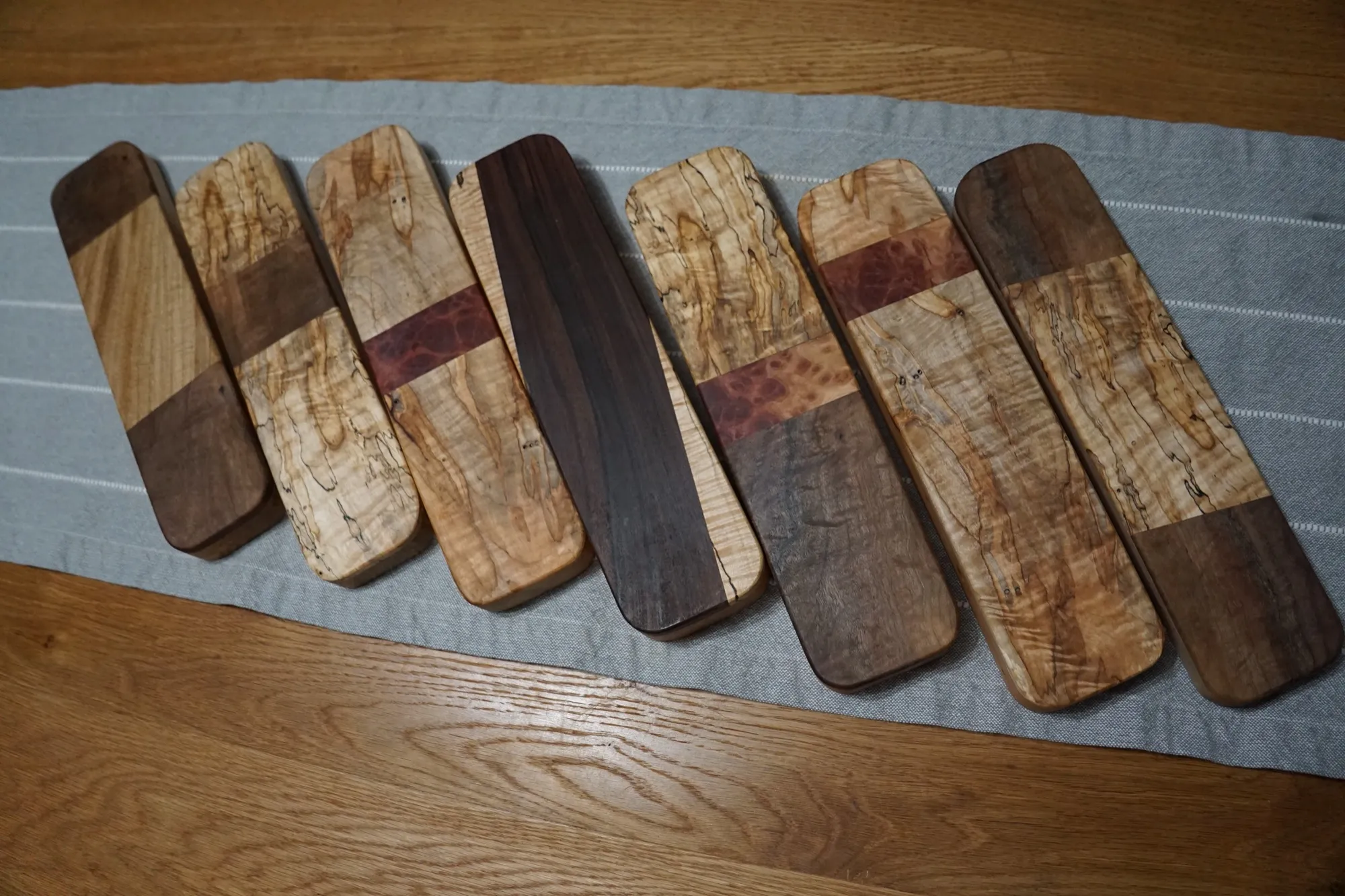 The current batch of two-layer clappers laid out on a gray table runner