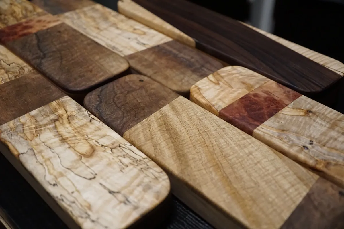 Close-up of spalted and burled clapper tops catching the light