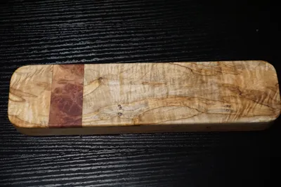 Rectangular clapper of burled maple with a narrow red mallee burl band near one end