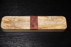 Rectangular clapper of spalted curly maple with a red mallee burl band across the center